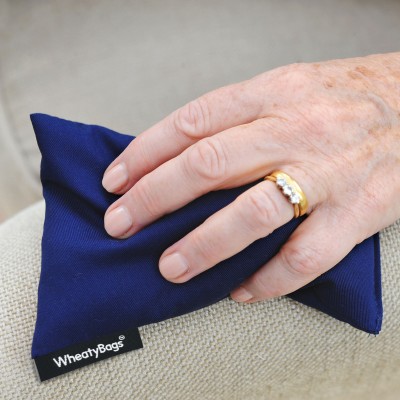 Wheat Bags Small Rectangle Heat Pack - Pack of 2 in Royal Blue Cotton Fabric Being Shown In Use